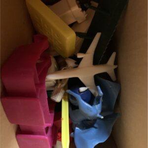 Miscellaneous little toys like a plastic airplane darts  hot wheels  and a cape